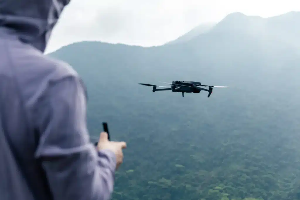 Flying drone in spring forest